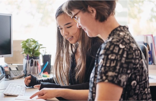student and staff member discussing document