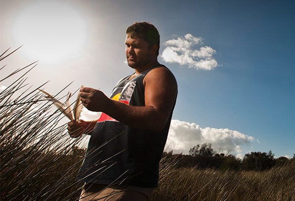 An indigenous man in a field