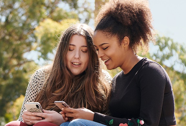 2 you women looking at their phones