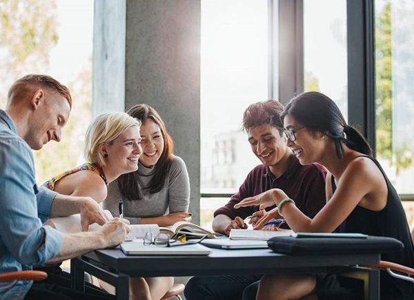 Image of a group of students sitting around a table in a library