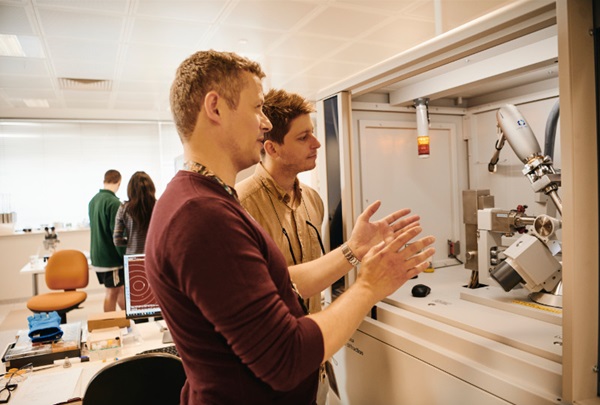 Technicians using laboratory machine